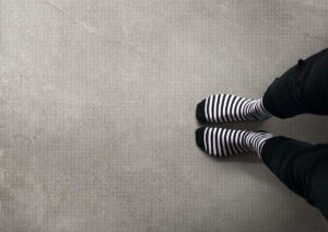 gresie si faianta de calitate | Looking Down On Striped Socks On Concrete Floor | Gresie Premium | Importator gresie faianta parchet de calitate din Italia