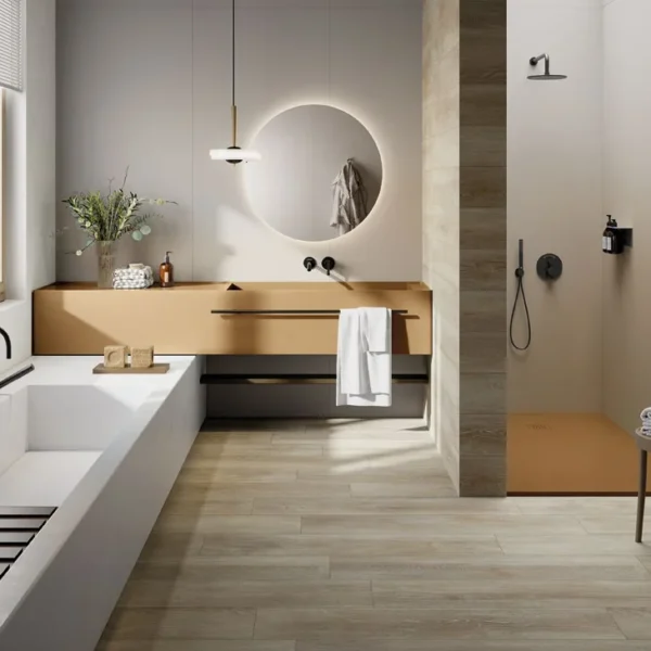Modern bathroom with a white freestanding bathtub, tan floating vanity, circular backlit mirror, and a beige-tiled shower area in neutral tones—bright and spa-like.